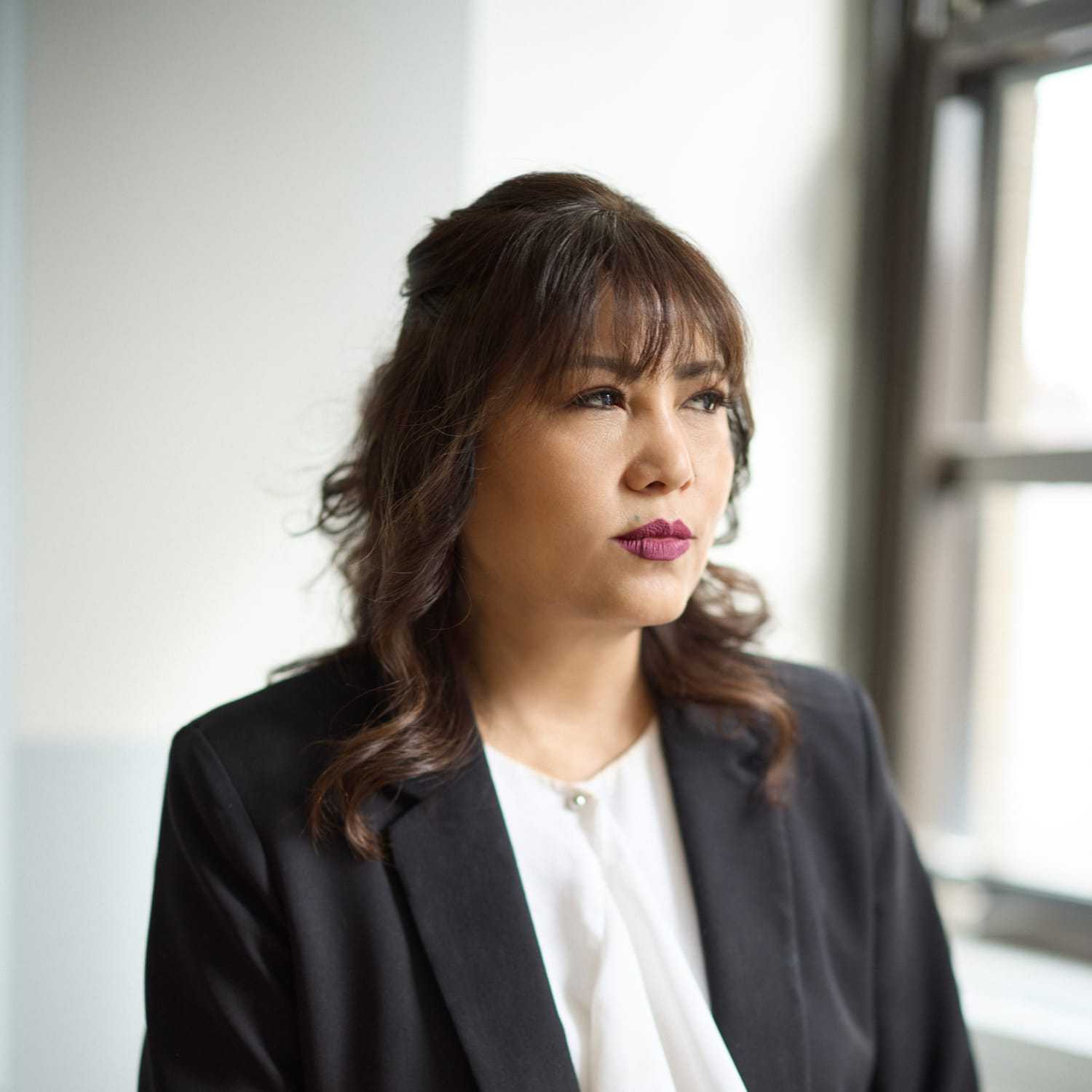 Portrait of Devi Limbu Shrestha, a professional stylist at Mizu Louis Licari, showcasing their expertise and style.